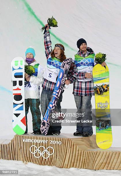 Peetu Piiroinen of Finland poses after winning the silver, Shaun White of the United States poses after winning the gold and Scott Lago after winning...