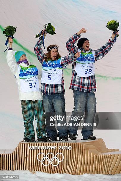 S gold medalist Shaun White , USA's Scott Lago , third, and Finland's Peetu Piiroinen, silver, celebrate on the podium after the men's Snowboard...