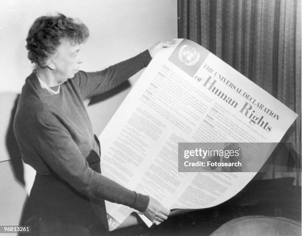 Eleanor Roosevelt holds up a copy of 'THE UNIVERSAL DECLARATION OF HUMAN RIGHTS', circa 1947. .
