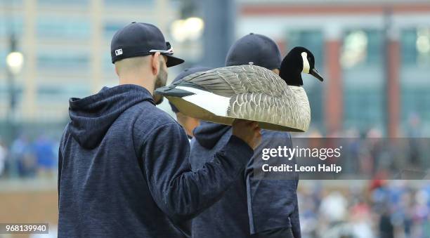 Mike Fiers of the Detroit Tigers carries the Rally Goose onto the fields after the Tigers defeated the Blue Jays at Comerica Park on June 2, 2018 in...