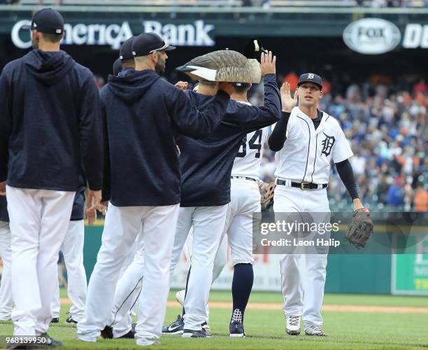 Mike Fiers of the Detroit Tigers carries the Rally Goose as JaCoby Jones celebrates a win over the Toronto Blue Jays at Comerica Park on June 2, 2018...