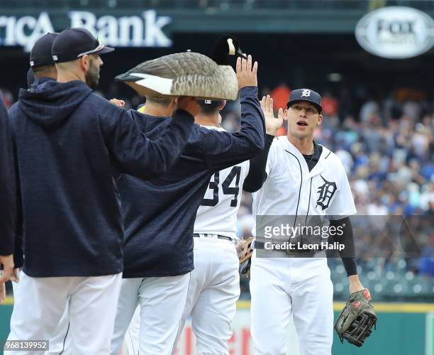 Mike Fiers of the Detroit Tigers carries the Rally Goose as JaCoby Jones celebrates a win over the Toronto Blue Jays at Comerica Park on June 2, 2018...