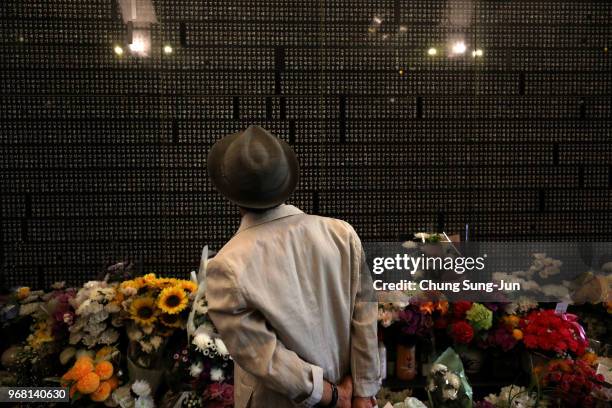 South Korean man watchs engraved name of his relative who died during the Korean War at Seoul National Cemetery on June 6, 2018 in Seoul, South...