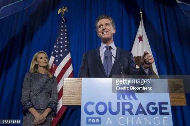 Gavin Newsom, Democratic candidate for governor of California, right, speaks as his wife Jennifer Siebel Newsom listens during a primary election...