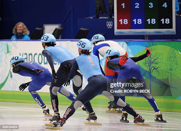 Apolo Anton Ohno of the US pushes teammate J.R. Celski during the men's 5,000m short-track relay semifinals at the 2010 Winter Olympics at the...