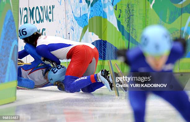 Italy's Claudio Rinaldi and France's Benjamin Mace fall down in the men's 5000m short-track relay semifinal at the Pacific Coliseum in Vancouver...