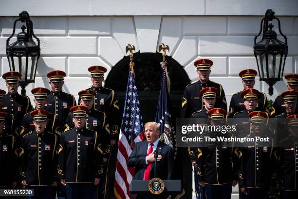 President Donald J. Trump, with the United States Army Chorus around him, sings at a "Celebration of America" event that replaced a celebration for...