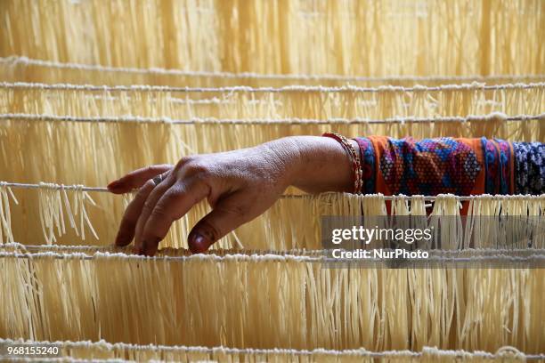 An Indian Muslim mansoori family woman dries up traditional sweet dish 'Vermicelli' or 'Sewaiyan' for sale ahead the muslims festival Eid-al-Fitr,...