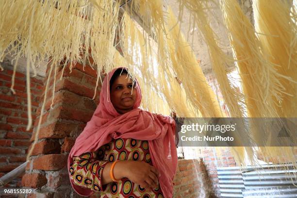 An Indian Muslim mansoori family woman dries up traditional sweet dish 'Vermicelli' or 'Sewaiyan' for sale ahead the muslims festival Eid-al-Fitr,...