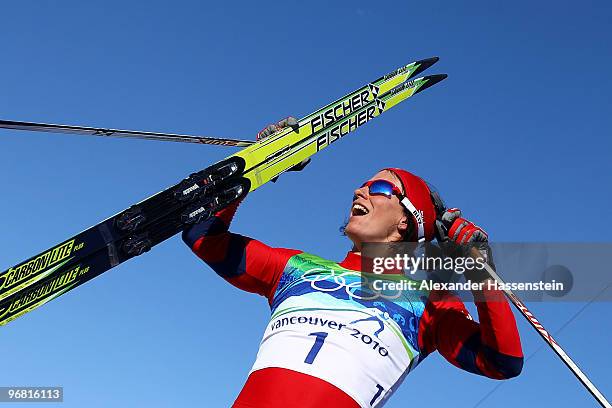 Marit Bjoergen of Norway celebrates after she finished first to win the gold medal in the Women's Individual Sprint C Final on day 6 of the 2010...