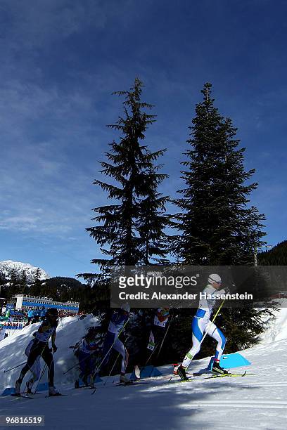 Katja Visnar of Slovenia leads a pack of skiiers up an incline during the Women's Individual Sprint C on day 6 of the 2010 Vancouver Winter Olympics...