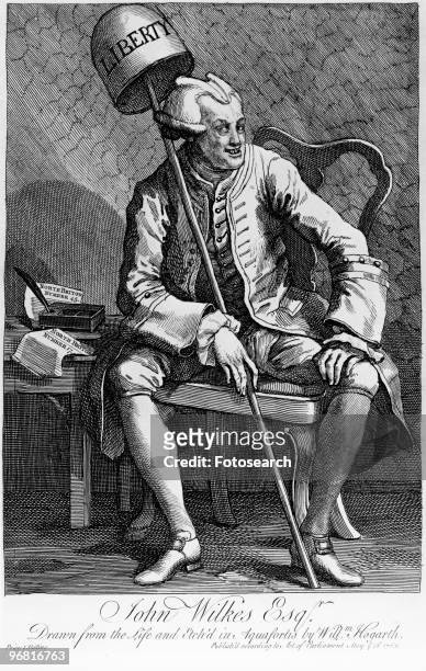 An engraving by William Hogarth of John Wilkes, Esq holding a 'Liberty' bell, circa 1763. .