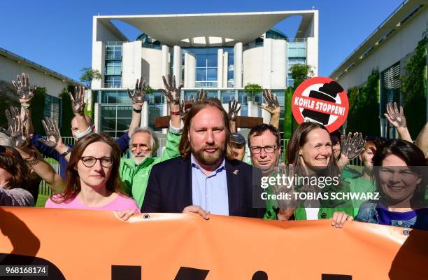 Politician of the Greens and member of the parliament Anton Hofreiter and environmental activists holding up their hands painted in black to call for...