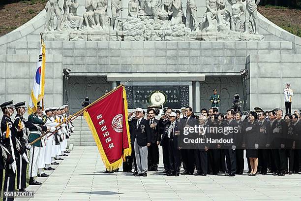 In this handout image provided by the South Korean Presidential Blue House, South Korean President Moon Jae-in salutes during a ceremony marking...