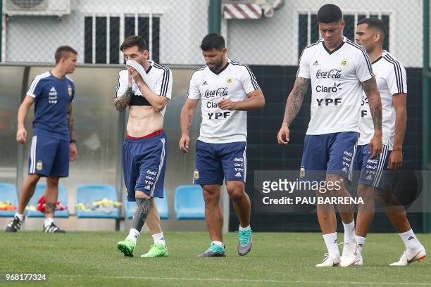 Argentina's forward Lionel Messi , Argentina's defender Marcos Rojo and Argentina's forward Sergio Aguero attend a training session at the FC...