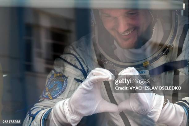 German astronaut Alexander Gerst gestures from inside a bus before the launch of the Soyuz MS-09 spacecraft at the Russian-leased Baikonur cosmodrome...