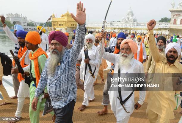 Indian Sikh radical activists shout pro-Khalistan slogans on the occasion of 34th anniversary of Operation Blue Star at the Golden temple in Amritsar...