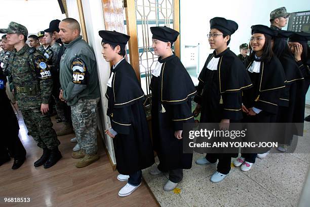 South Korean students of Taesungdong Elementary School wait to participate in a graduation ceremony at Taesungdong freedom village near the border...