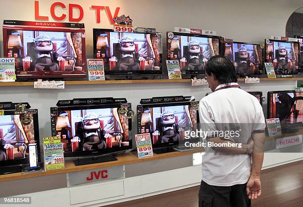 Shoppers look at liquid-crystal display televisions on sale in a shopping mall in Singapore, on Thursday, Feb. 18, 2010. Singapore will probably...