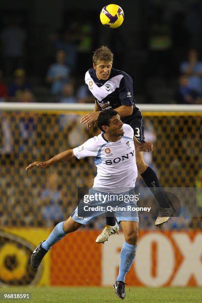 Adrian Leijer of the Victory heads the ball over the top of John Aloisi of Sydney during the A-League Major Semi Final first leg match between the...