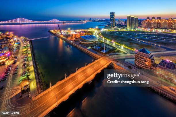 the night view of xinghai bay on dalian city. - xing stock pictures, royalty-free photos & images