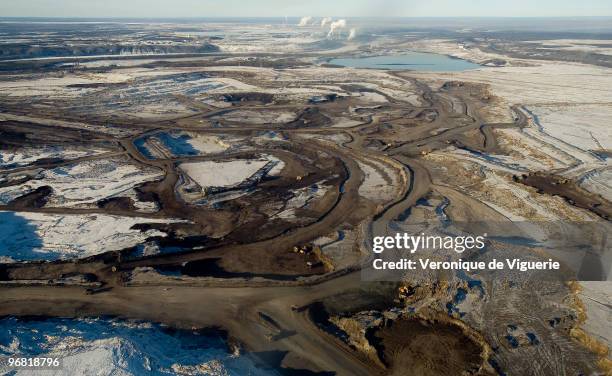 Aerial views of the mines of Syncrude Canada Ltd and Suncor Energy Inc, inlcuding one of Suncor's tailing ponds, with oil remains floating on it, as...