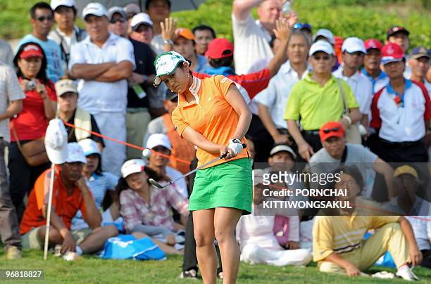 Japanese golfer, Ai Miyazato, chips the ball onto the green during the first day of the Honda-PTT LPGA Thailand 2010 golf tournament, in the Thai...