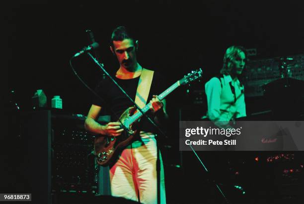 Frank Zappa and band member Eddie Jobson perform on stage at The Playhouse Theatre on February 14th, 1977 in Edinburgh, Scotland.