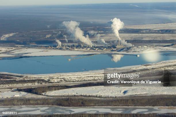 Aerial views of the mines of Syncrude Canada Ltd and Suncor Energy Inc, inlcuding one of Syncrude's tailing ponds, with oil remains floating on it....