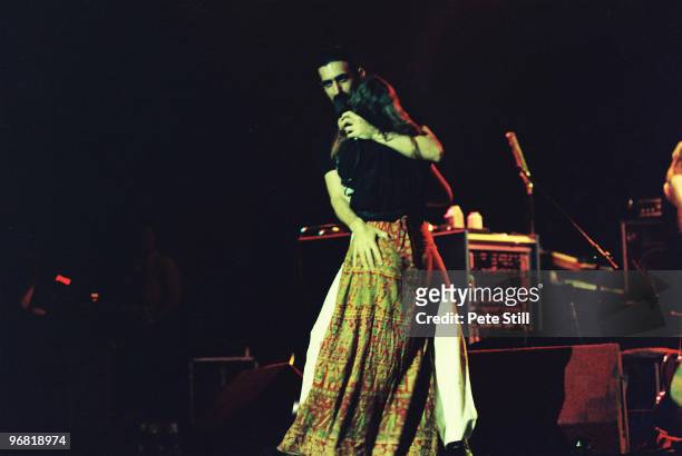 Frank Zappa cavorts on stage with a member of the audience while performing at The Playhouse Theatre on February 14th, 1977 in Edinburgh, Scotland.