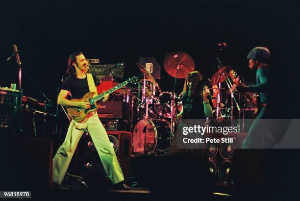 Frank Zappa performs at The Playhouse Theatre, with a member of the audience and band guitarist Ray White, on stage on February 14th, 1977 in...
