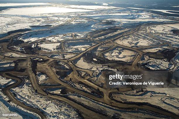 Aerial views of the mines of Syncrude Canada Ltd and Suncor Energy Inc. Tar sands, or oil sands, are very dense and contain a form of petroleum The...