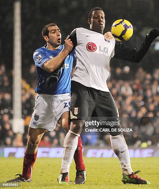 Fulham's new signing Stefano OKaka competes with Portsmouth's Tal Ben Haim during their Premiership match at home to Fulham at Craven Cottage...