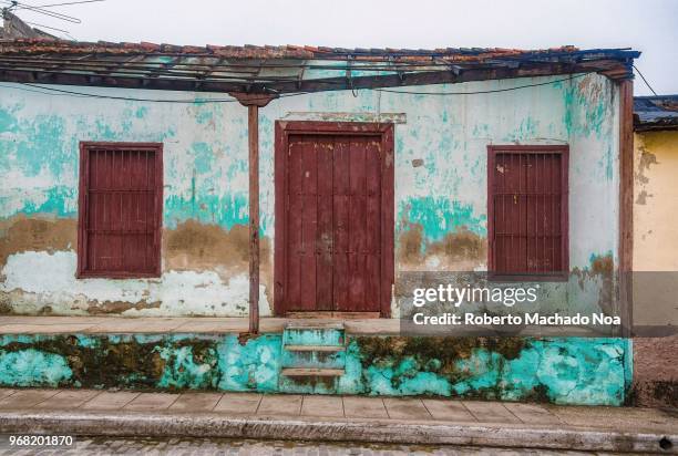 Weather and abandonment worn out house facade. Cuba colonial architecture has suffered many years of economic hardship.