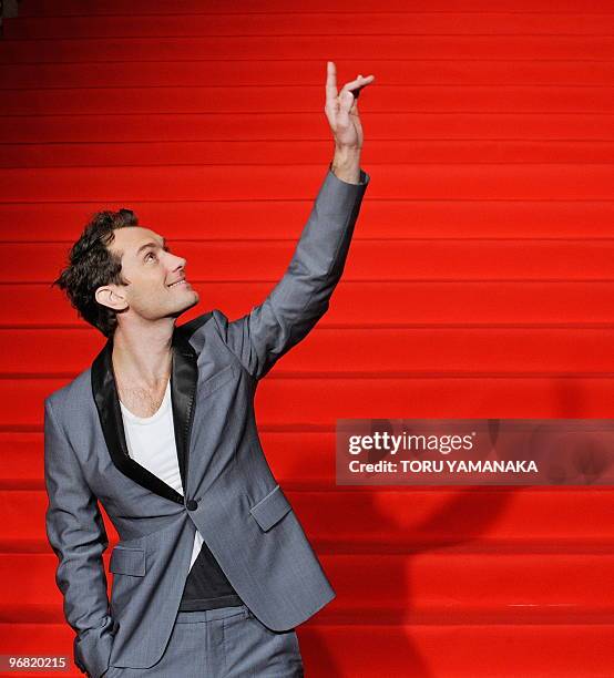 British actor Jude Law waves to Japanese fans on the red carpet before the Japan premiere of the film "Sherlock Holmes" in Tokyo on February 18,...