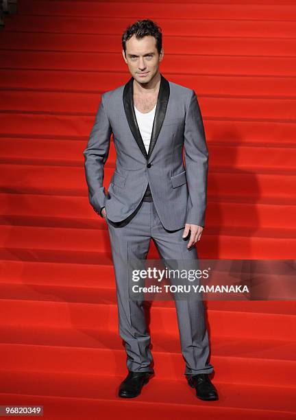 British actor Jude Law poses for photographers on the red carpet before the Japan premiere of the film "Sherlock Holmes" in Tokyo on February 18,...