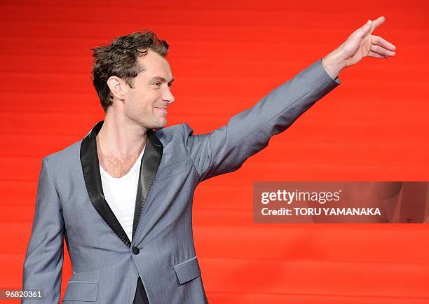 British actor Jude Law waves to Japanese fans on the red carpet before the Japan premiere of the film "Sherlock Holmes" in Tokyo on February 18,...