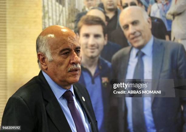 Head of the Palestinian Football Association Jibril Rajoub stands in front of a sign addressed to Argentina's star player Lionel Messi during a press...