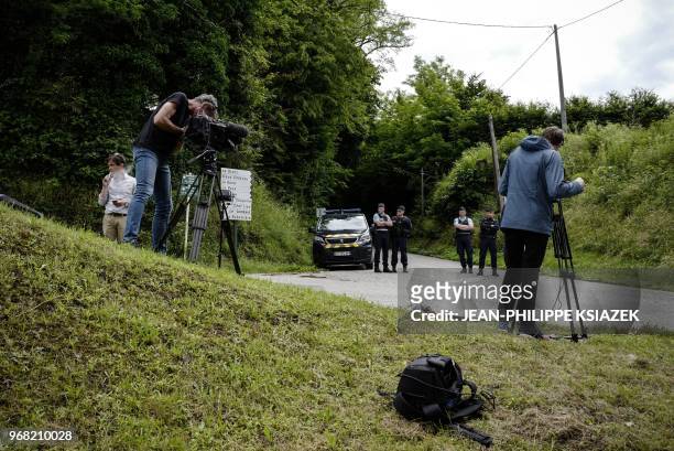 Journalists report as French gendarmes block a road leading to the home of French confessed murderer Nordhal Lelandais' parents as it is being...