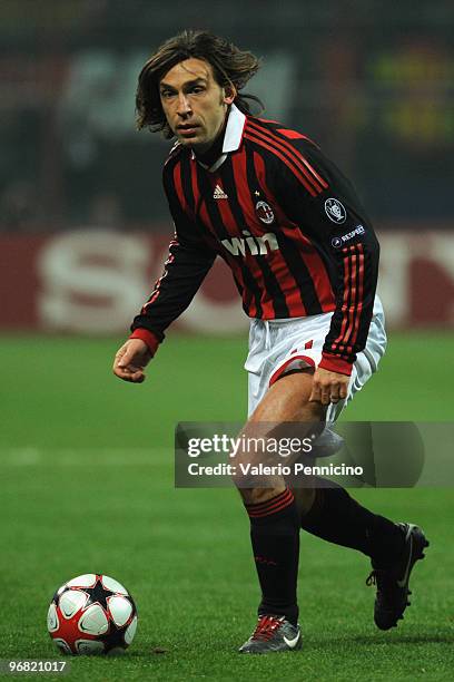 Andrea Pirlo of AC Milan runs with the ball during the UEFA Champions League round of 16 first leg match between AC Milan and Manchester United on...