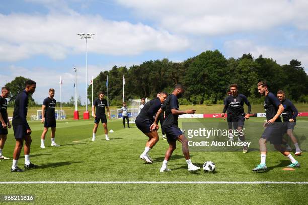 Raheem Sterling and Adam Lallana of England in action during the England training session at St Georges Park on June 6, 2018 in Burton-upon-Trent,...