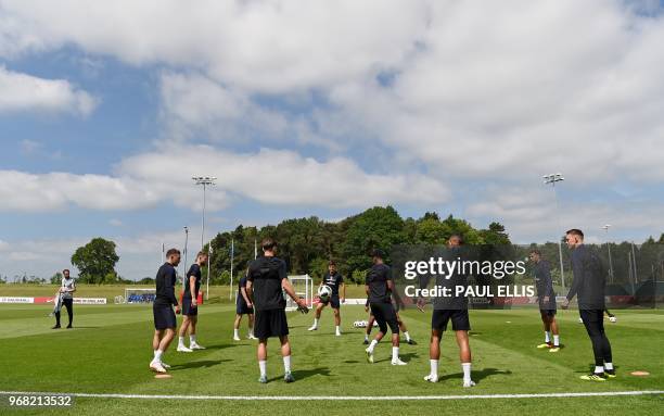 England's manager Gareth Southgate watches his players pass the ball during a open training session at St George's Park in Burton-on-Trent on June 6...