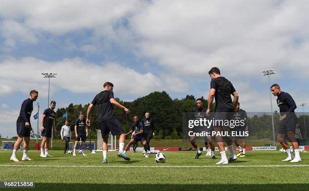 England's midfielder Adam Lallana passes the ball to England's defender Trent Alexander-Arnold during a open training session at St George's Park in...