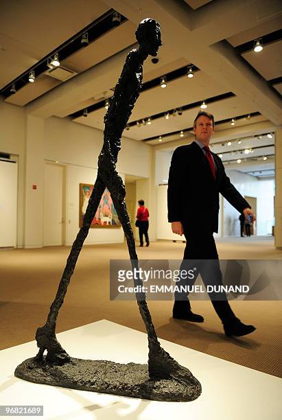 Homme qui marche I", a sculpture by artist Alberto Giacometti, is on display at Sotheby's during a preview at Sotheby's, January 20 in New York. The...