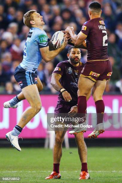 Tom Trbojevic of the Blues catches the ball against Valentine Holmes of the Maroons to then score a try during game one of the State Of Origin series...