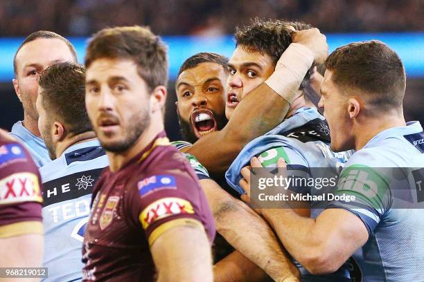 Latrell Mitchell of the Blues celebrates with Josh Addo-Carr of the Blues after he scores a try against Ben Hunt of the Maroons during game one of...