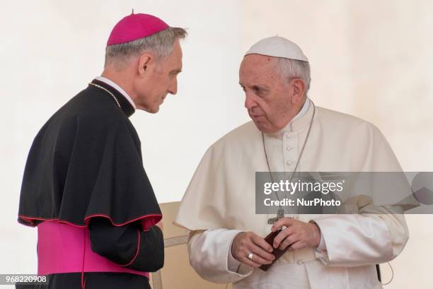 Pope Francis talks with Archbishop Georg Ganswein at the end of speech during his weekly general audience in St. Peter's Square at the Vatican, 6...