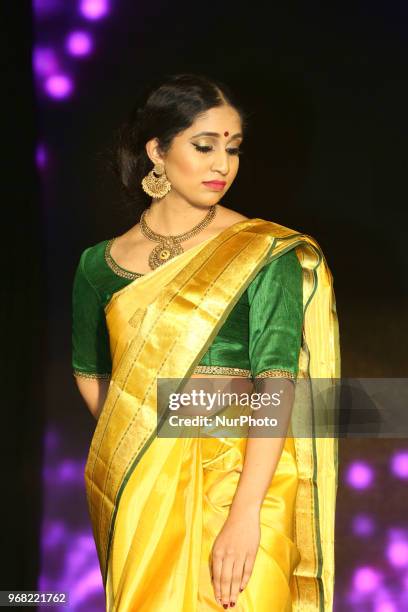 Indian model wearing an elegant and ornate Kanchipuram saree during a South Asian bridal fashion show held in Scarborough, Ontario, Canada.