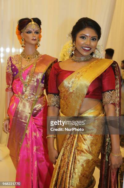 Indian model wearing an elegant and ornate Kanchipuram saree during a South Asian bridal fashion show held in Scarborough, Ontario, Canada.