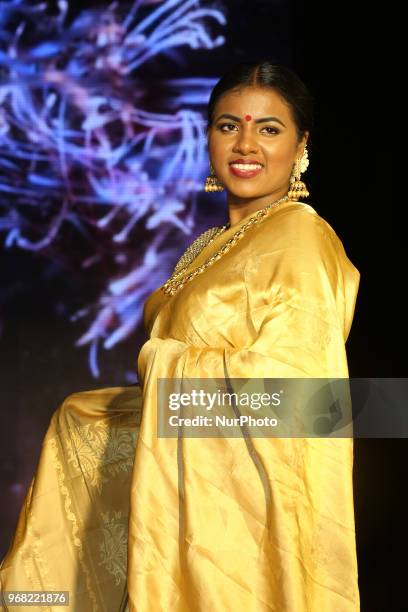 Indian model wearing an elegant and ornate Kanchipuram saree during a South Asian bridal fashion show held in Scarborough, Ontario, Canada.